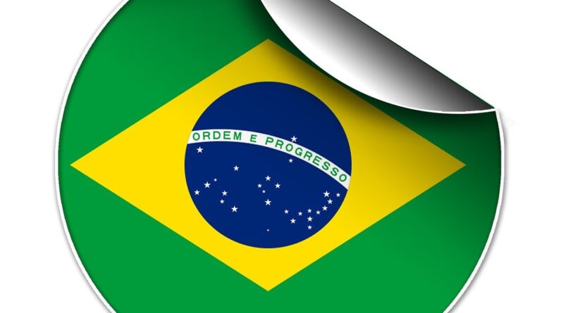 Desenho da bandeira do Brasil em um formato circular com a parte superior direita dobrada, como se fosse um adesivo descolando.